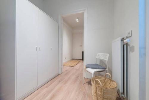 a room with a hallway with a chair and an open door at Spacious Apartment Lana, Clean Comfy in Tilburg