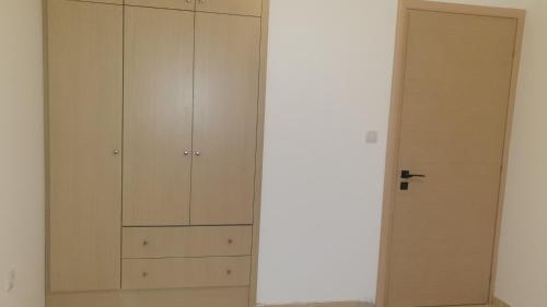 a closet with white cabinets and a door at Niriides Sea View Apartment in Kanali