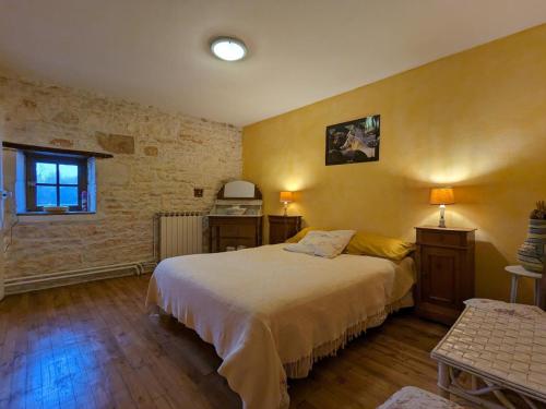 a bedroom with a large bed in a room at Moulin Authentique avec Jardin Privé et Activités pour Familles et Amis en Bord de Rivière - FR-1-653-251 in Saint-Mary