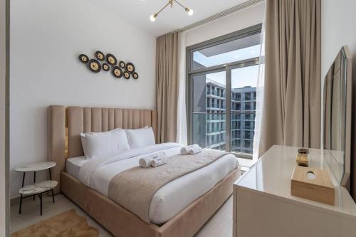a bedroom with a bed and a large window at Brand New Listing & Studio City & Czechin in Dubai