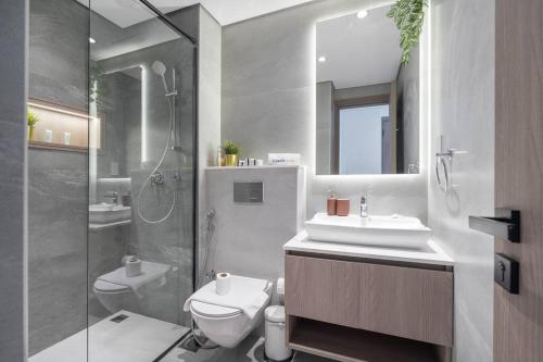 a bathroom with a sink and a toilet and a shower at Brand New Listing & Studio City & Czechin in Dubai