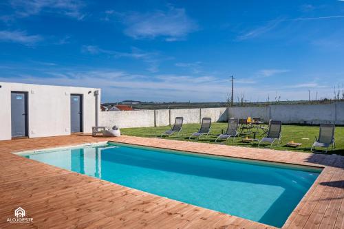 a swimming pool on top of a house at Palmeiras Beach House - Santa Cruz in Santa Cruz