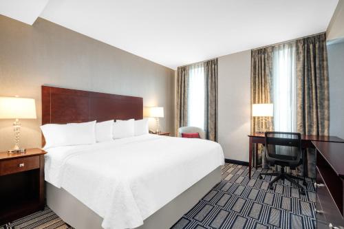 a hotel room with a large bed and a desk at Hampton Inn & Suites Providence Downtown in Providence