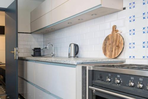 a kitchen with a stove and a sink at Cozy Room, Just Renovated in Tilburg