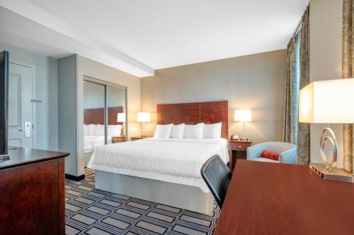 a hotel room with a large bed and a desk at Hampton Inn & Suites Providence Downtown in Providence