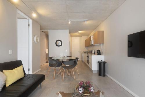 a living room with a couch and a table at 105 On KOI by Host Agents in Ballito