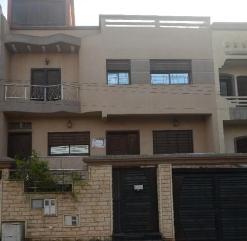 an apartment building with two balconies on top of it at Elegant villa for family and business trips in El Jadida