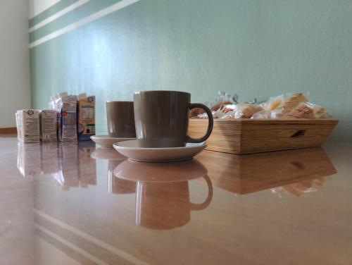 a table with a coffee cup and a wooden box at Bed and Breakfast Cattinara in Trieste