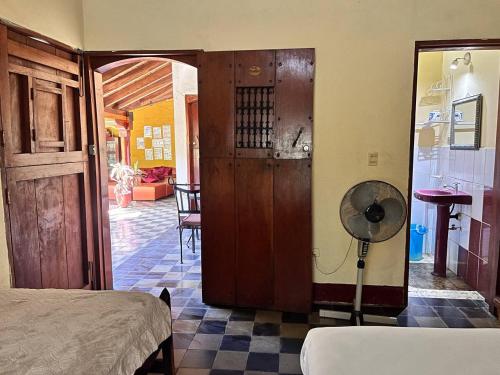 a room with a bed and a room with a fan at ViaVia Leon in León