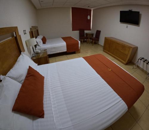 Postel nebo postele na pokoji v ubytování Hotel Yvette