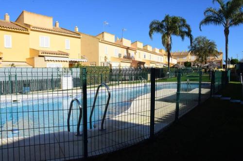 a fence in front of a swimming pool at Preciosa casa cerca del mar in La Redondela