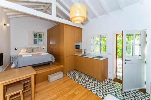a bedroom with a bed and a desk at Casa das 7 Leiras in Queijada