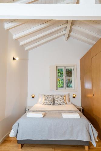 a bedroom with a large bed in a white room at Casa das 7 Leiras in Queijada