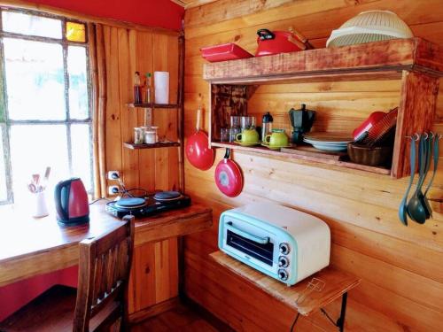 uma cozinha com um micro-ondas num balcão de madeira em BIVAQUE hospedaje em Tigre