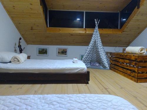 a bedroom with two beds and a christmas tree at Chalet Laguna Sagrada de Fuquene in Fúquene