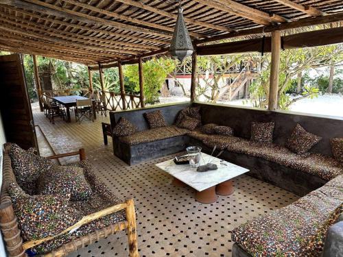 a living room with couches and a table at Villa Maua Exclusive in Matemwe