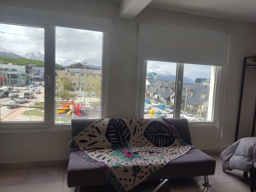 a couch in a living room with a view of a city at Olivia View II in Ushuaia