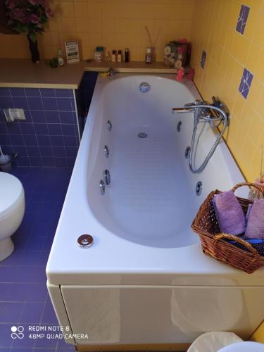 a white bath tub in a bathroom with a toilet at A casa di Lucy in Rimini