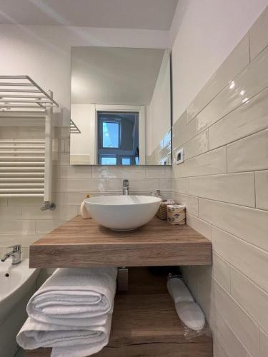 a white bathroom with a sink and a mirror at Palazzo Palumbo in Procida