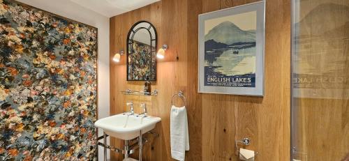 a bathroom with a sink and a mirror at The Drunken Duck Inn in Ambleside