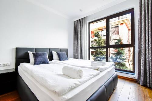 a large bed in a room with a large window at Top 10 3br2bh Jacuzzi Free Parking in Sofia