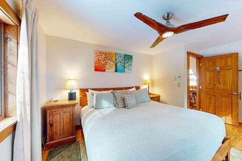 a bedroom with a bed and a ceiling fan at The Crossroads at Jay in Jay