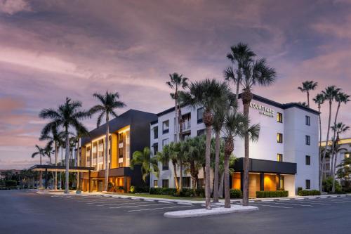 a rendering of a hotel with palm trees in a parking lot at Courtyard by Marriott - Naples in Naples