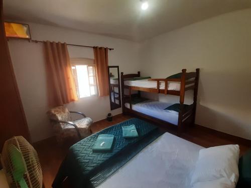 a room with two bunk beds and a window at POUSADA MALU in Bragança Paulista