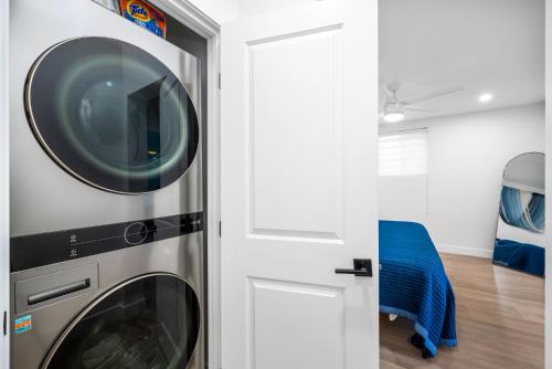 a washer and dryer in a room with a door at 130 Anderson St A in Sunset Beach