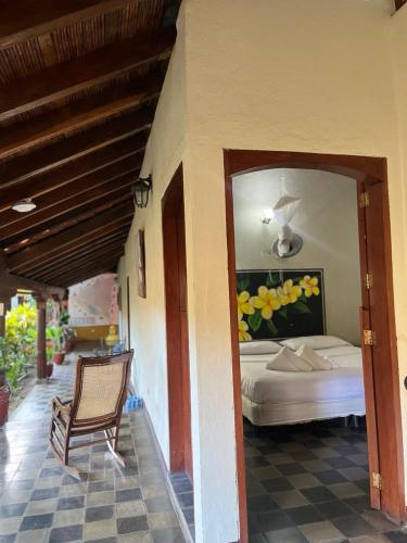 a bedroom with a bed and a chair in a room at ViaVia Leon in León