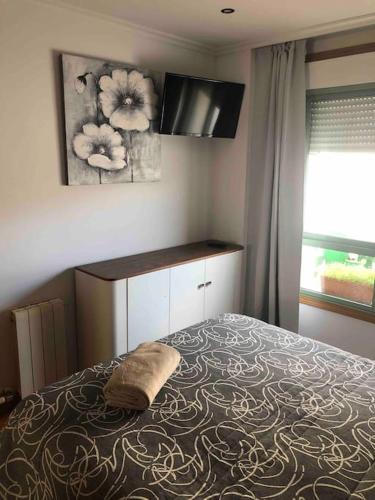 a bedroom with a bed with a pillow on it at Ponteareas Precioso apartamento . VUT-PO-011959 in Ponteareas