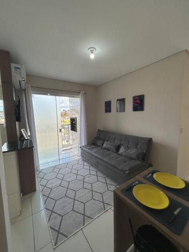 a living room with a couch and a table at Apartamento 246 in Rio Negrinho