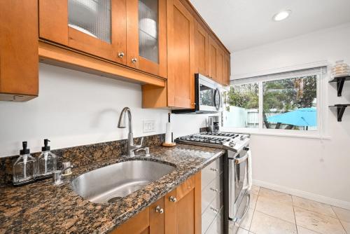 a kitchen with a sink and a stove at 1313 S Coast Hwy in Laguna Beach