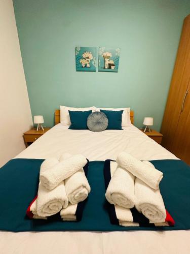 a bedroom with a bed with towels on it at Wardina Holiday Home Maisonette in Munxar