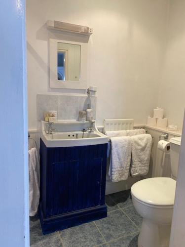 a bathroom with a sink and a toilet at White House Farm 