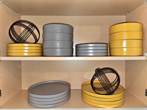 a bunch of bowls and plates on a shelf at RJ's Retreats in Von Ormy