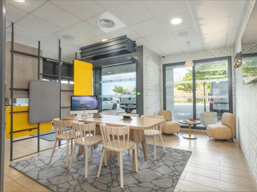 a dining room with a table and chairs at B&B HOTEL Fort-de-France in Fort-de-France
