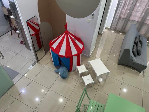 a room with a red and white umbrella on the floor at Mount Austin Manhanttan Sovo by Cactus Homestay in Johor Bahru