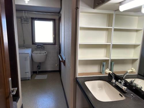 a bathroom with a sink and a toilet and a mirror at Shin-SHIN-Kakamigahara - Vacation STAY 16114 in Kakamigahara