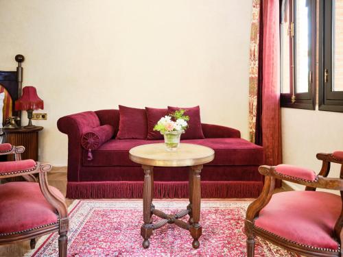 a living room with a purple couch and a table at Dar Jasmine in Chefchaouene