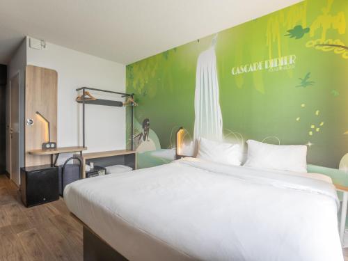 a bedroom with a white bed and a green wall at B&B HOTEL Fort-de-France in Fort-de-France