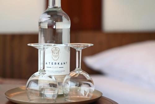 a bottle of wine and two glasses on a table at Strandhotel Salty in Büsum