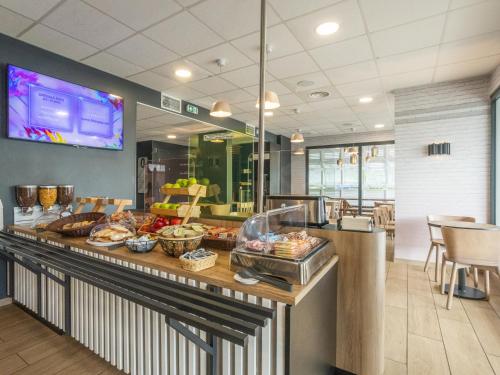 a buffet in a restaurant with food on a counter at B&B HOTEL Fort-de-France in Fort-de-France