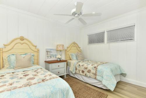 a bedroom with two beds and a ceiling fan at 2 Bedroom BACK Apt at OCEANFRONT HOME on 15th St in Newport Beach