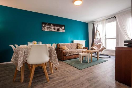 a living room with a table and a couch at *Cosy Home 20' Paris 25' Disney - Free WIFI* in Villiers-sur-Marne