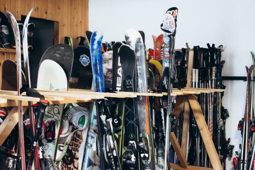 a bunch of skis and snowboards are lined up on shelves at Маріна Драгобрат in Dragobrat