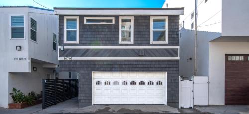 a house with a white garage door in front of it at Sunset Island 3 Level Home on the Water sleeps 10 in Sunset Beach