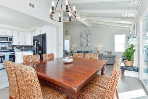 a dining room with a wooden table and chairs at Sunset Island 3 Level Home on the Water sleeps 10 in Sunset Beach