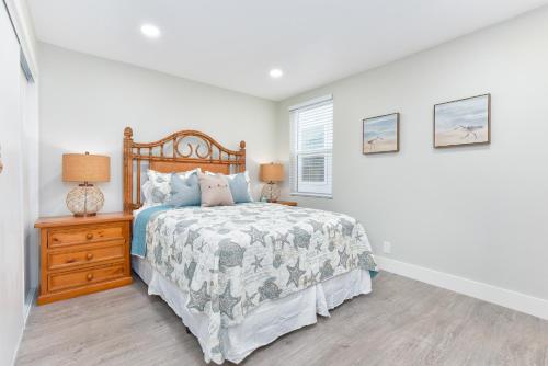 a bedroom with a bed and a dresser and a window at Sunset Island 3 Level Home on the Water sleeps 10 in Sunset Beach