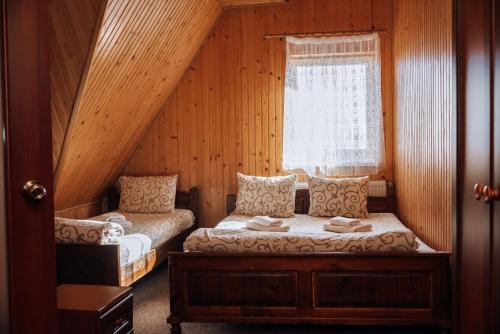 a bedroom with two beds and a window at Маріна Драгобрат in Dragobrat